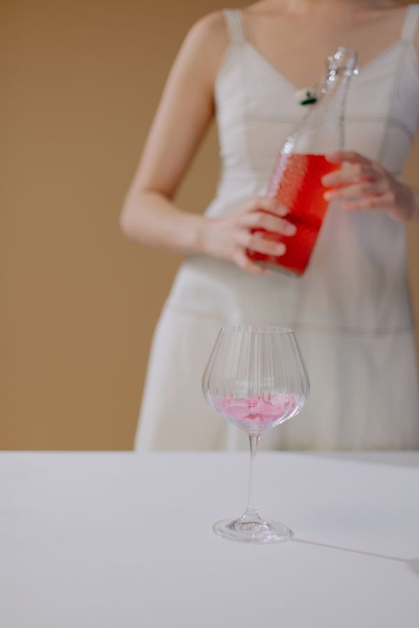 Instagram post: bottle of rosé wine held at a summer table